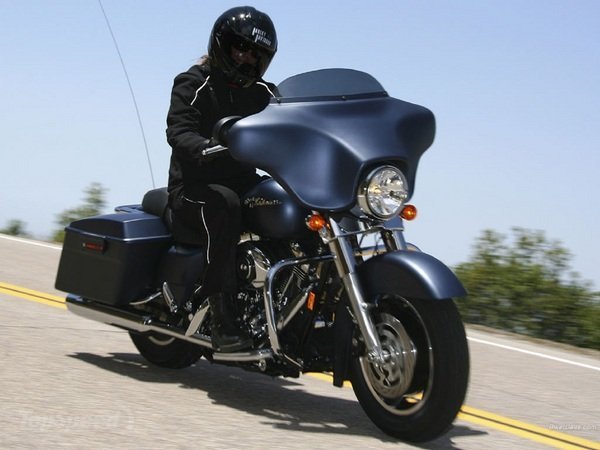 Man in all black riding an all black motorcycle