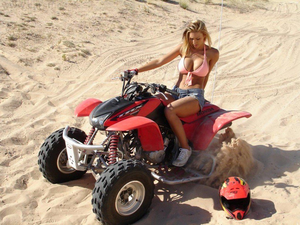 Good looking woman sitting on an ATV