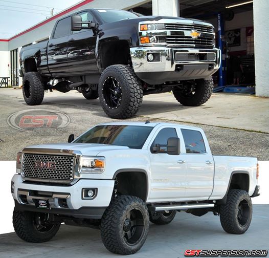 Two Lifted Chevy trucks all black and all white