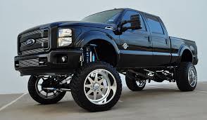 Black Ford F-250 jacked with wheels