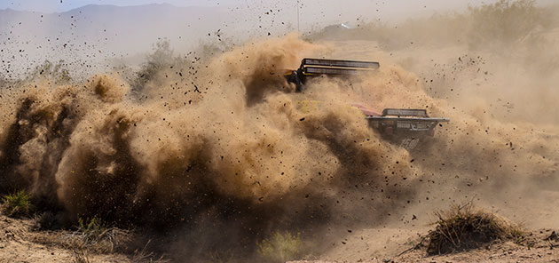 champ car doing a 360 in the desert sand
