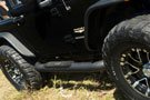 A Jeep rocking the Aries 4" Big Step Round Side Bar
