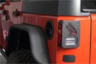 Textured black powder-coated aluminum tail light cover on a Jeep Wrangler JK