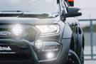 Illuminated PIAA LP 570 LED Driving Lamps on a black Ford vehicle