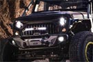 Jeep sporting Pro Comp round driving headlights