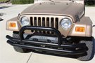Textured black 	Rampage Front Double Tube Bumper w/ Hoop on a Jeep