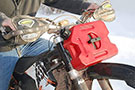 RotopaX 1-Gallon Gasoline Pack mounted on a motorcycle