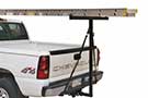Black steel Extend-a-Truck installed on pickup truck's rear carrying a ladder