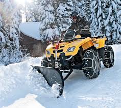 Atv with a snowplow at work
