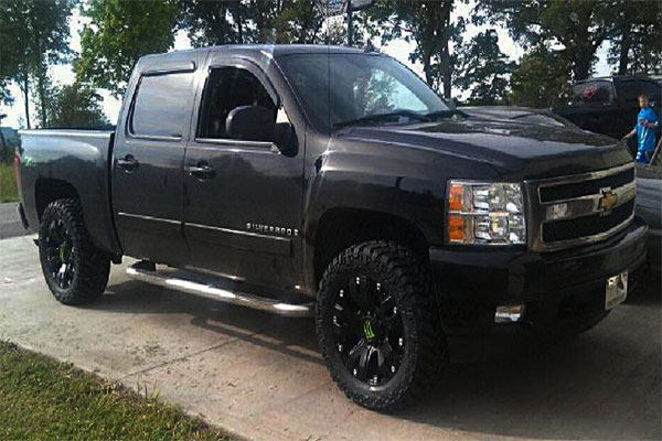 Black chevy truck with drop star wheels