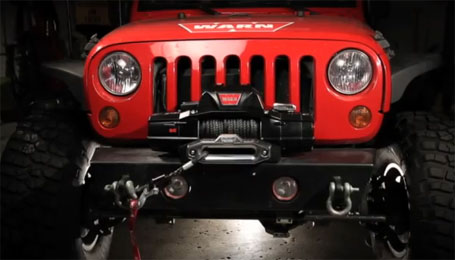 Red Jeep wrangler with a Warn winch