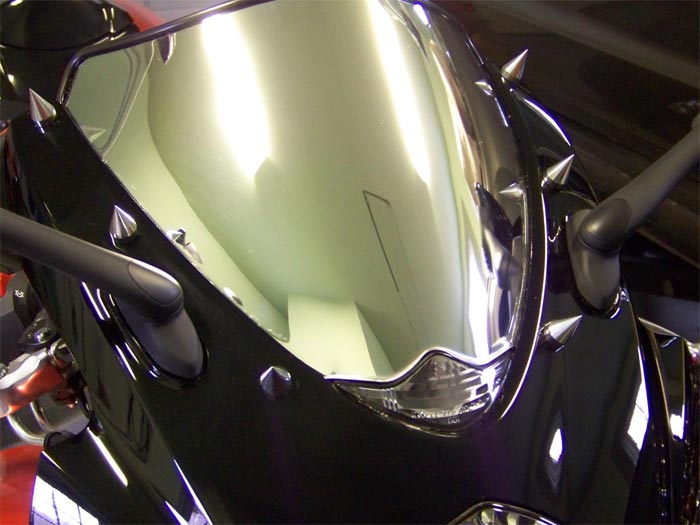 close up view of a mirror finish motorcycle windscreen