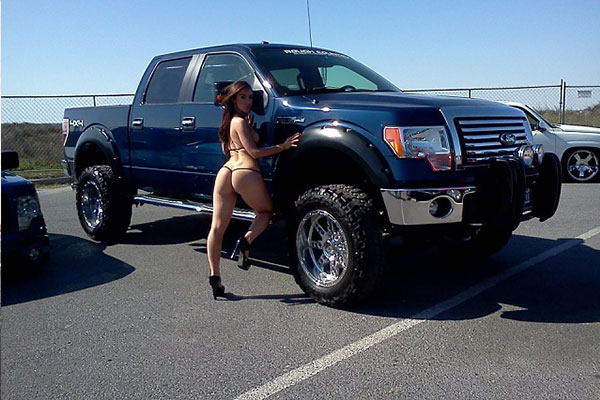 All black Ford F-150 with a girl in a T-back