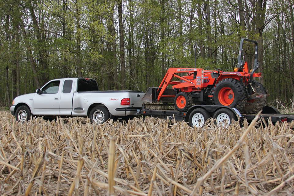 Ford pulling farm equipment