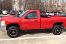 2-Step Wheel-to-Wheel Nerf Bars w/ Bed Access on a red Chevy pickup truck