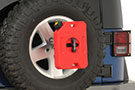 Red RotopaX Gas Oil Mix Pack mounted on a Jeep's spare tire